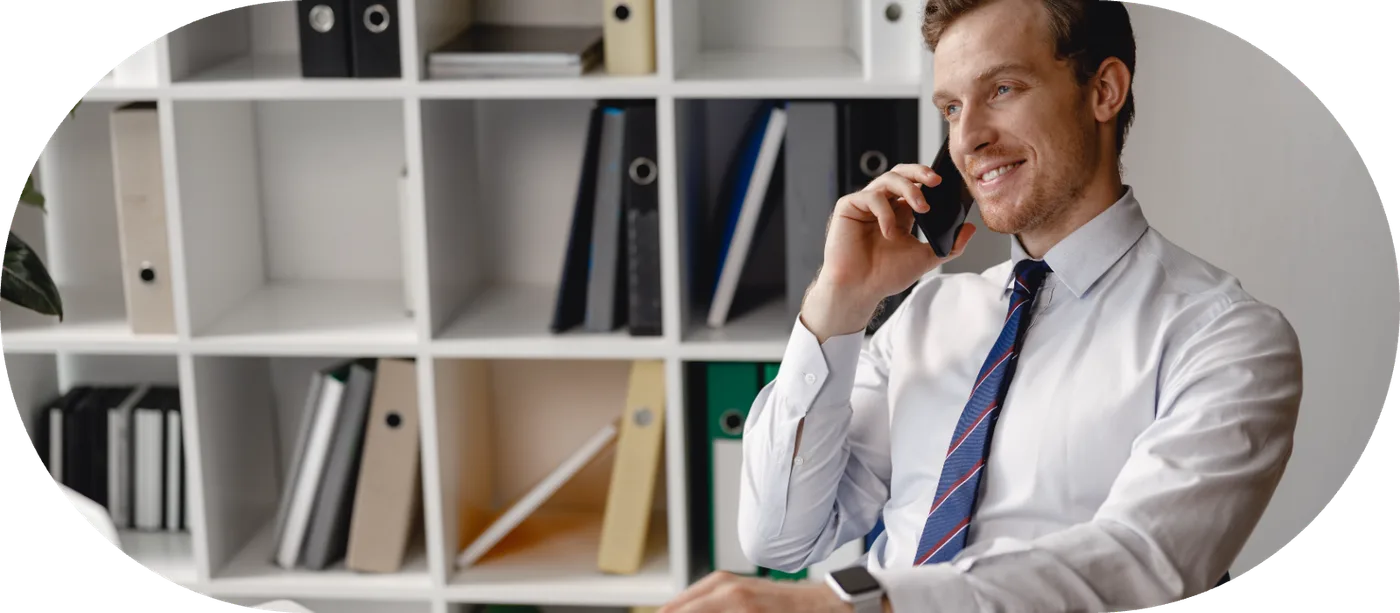 A business owner taking a call at their desk