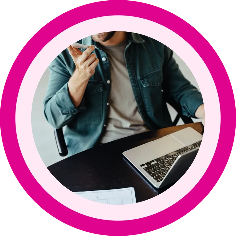 A business owner speaking on his mobile at his desk, calling out as the business