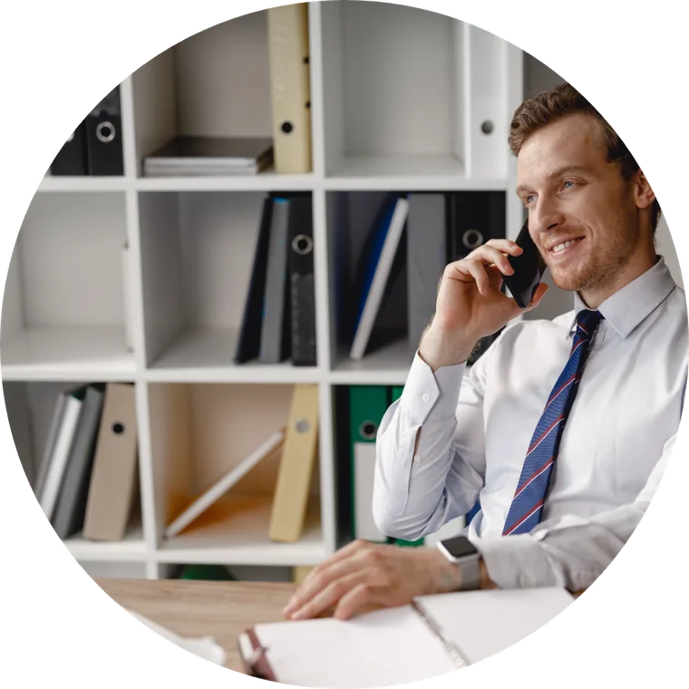 A business owner taking a call at their desk